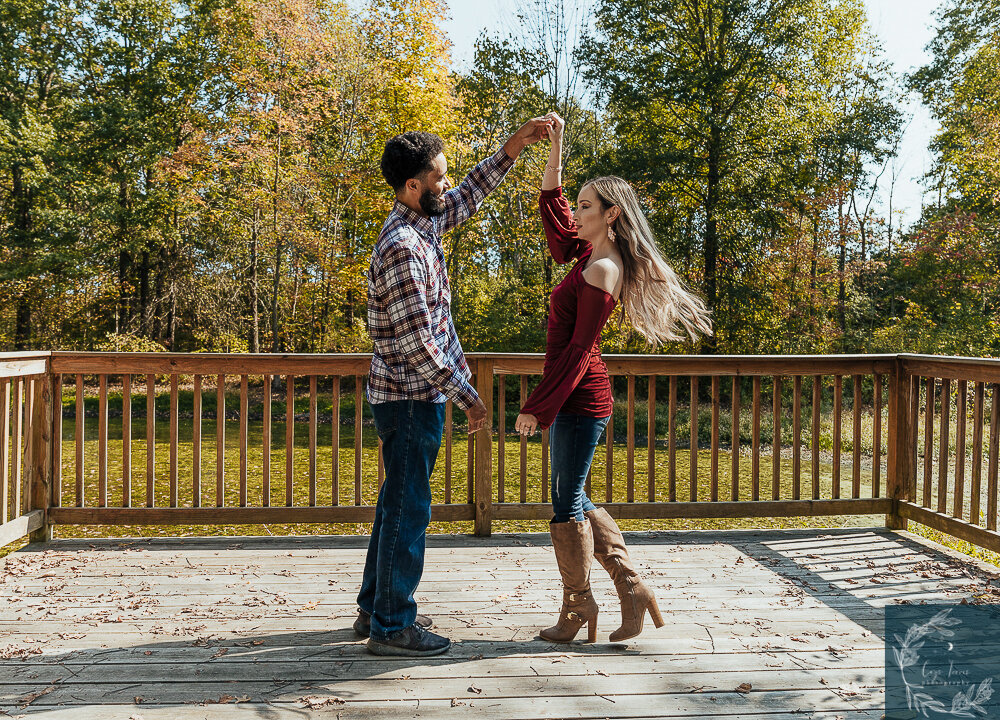 groom to be twirls his bride to be.