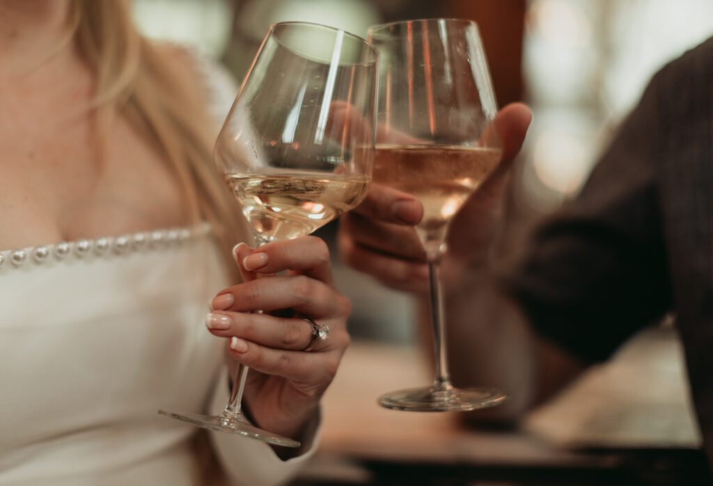 Engagement Session at Goodnight Restaurant toasting with wine at the bar.