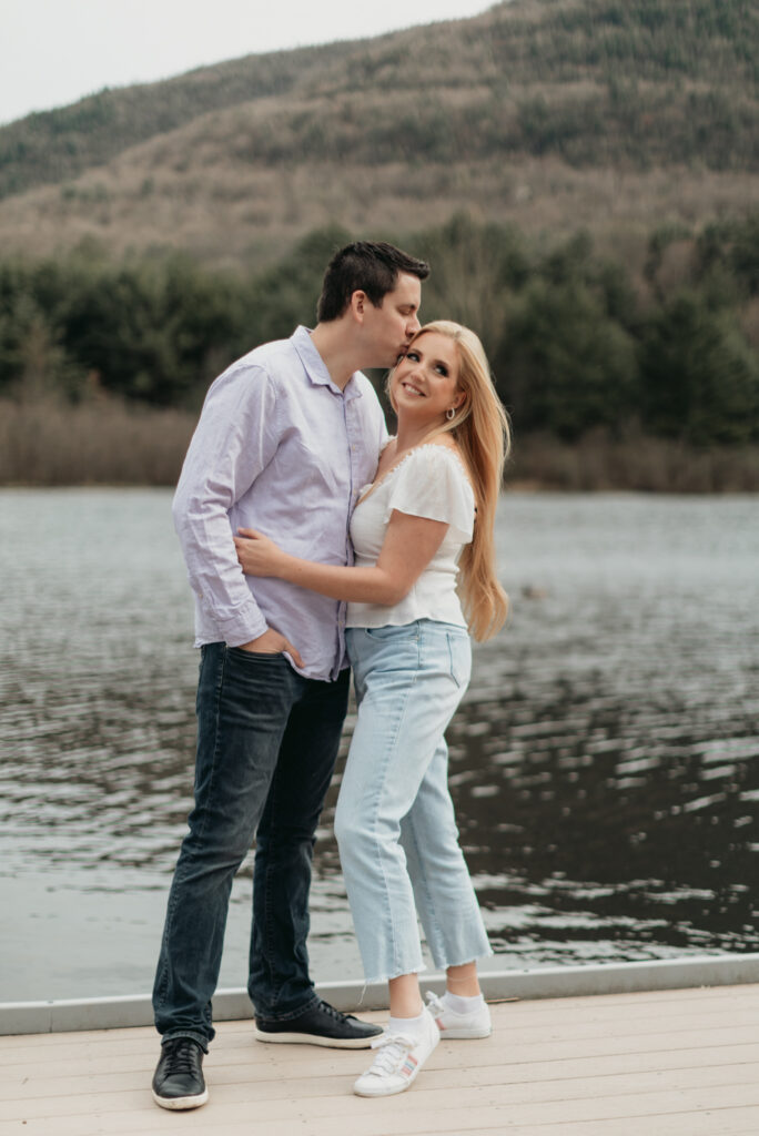 Engagement Session at Kenneth L. Wilson Campground. Woodstock, NY. couple walking away from camera. beautiful landscape, bride looks back smiling, groom kisses her forehead