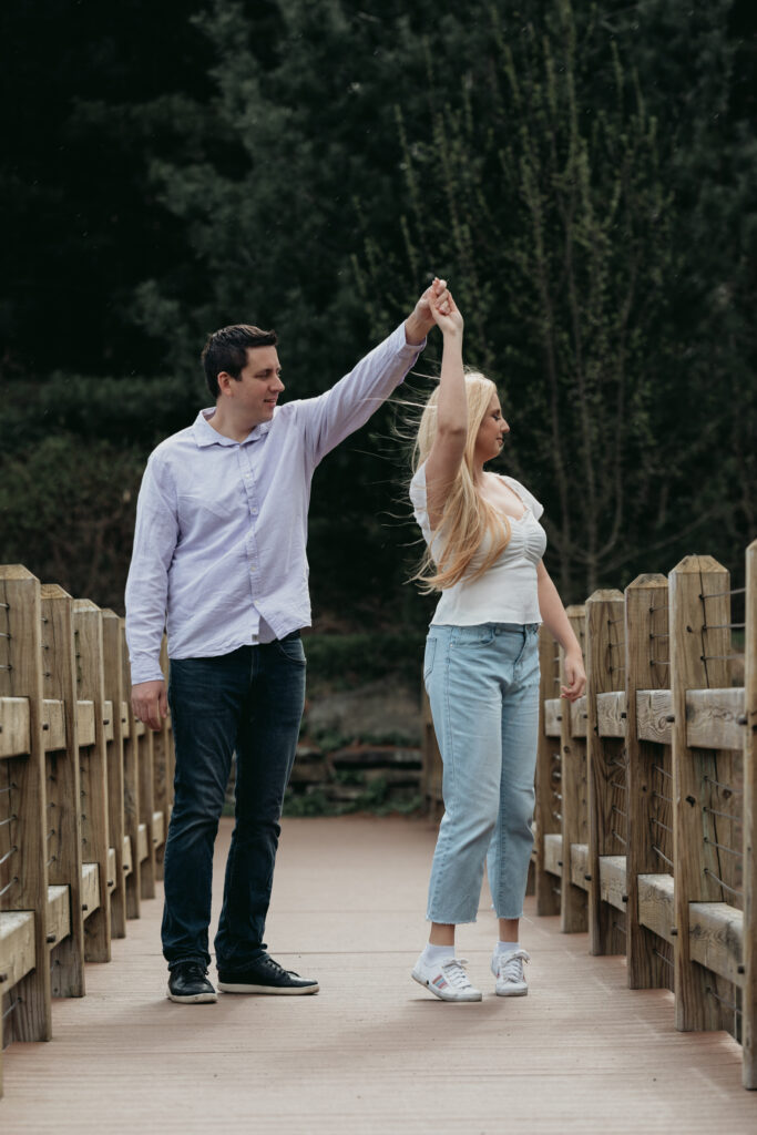 Engagement Session at Kenneth L. Wilson Campground. Woodstock, NY. couple walking on bridge. beautiful landscape, couple dancing, groom twirls bride.