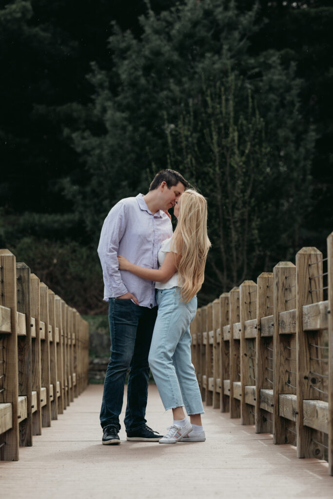 Engagement Session at Kenneth L. Wilson Campground. Woodstock, NY. couple walking on bridge. beautiful landscape, couple shares a kiss.