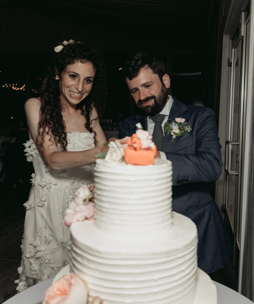 Couple cutting wedding cake at their reception Boscobel House and Gardens Cold Spring New York Hudson Valley