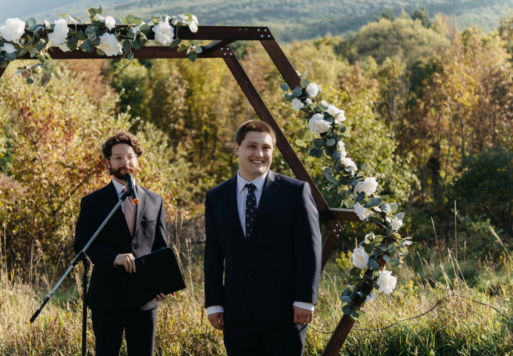 groom waiting down the aisle to receive his bride during the wedding ceremony