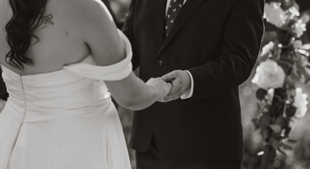 black and white close up shot of couple holding hands