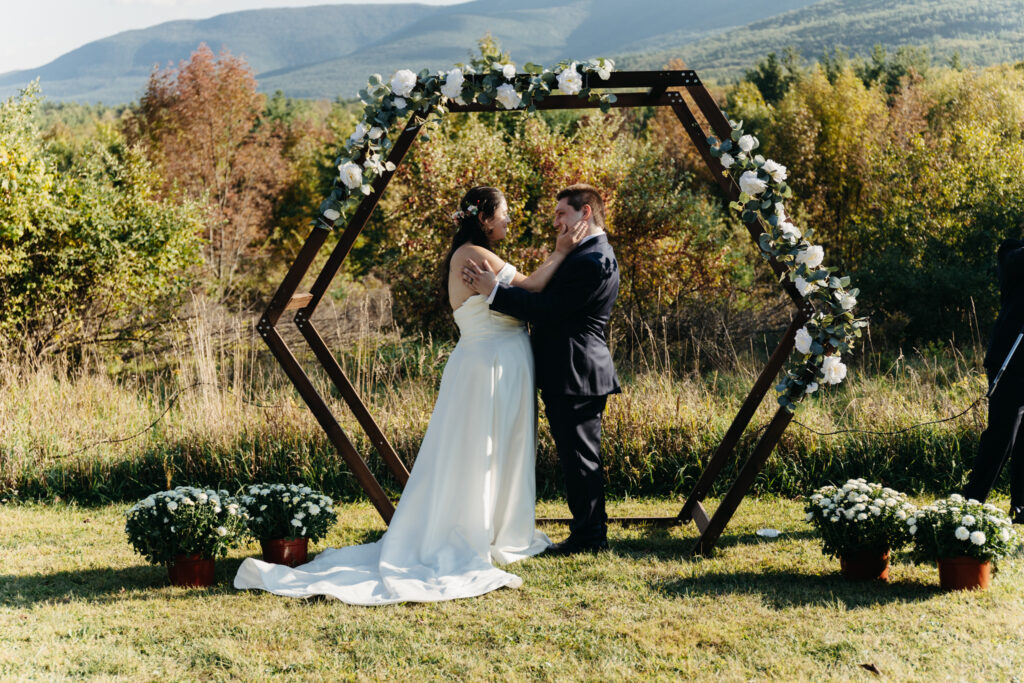 bride and groom take each other in after their first kiss as husband and wife