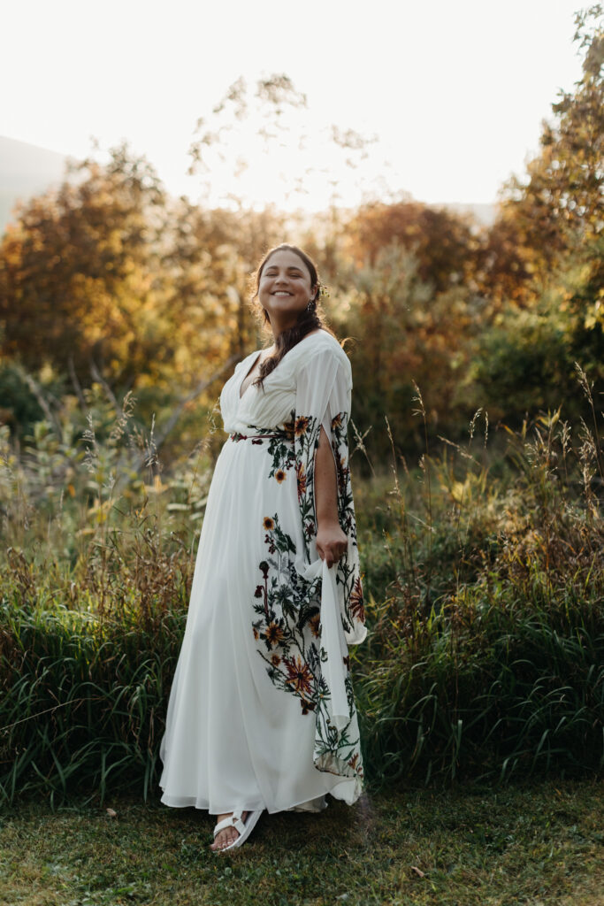 bride smiling in her floral reception dress