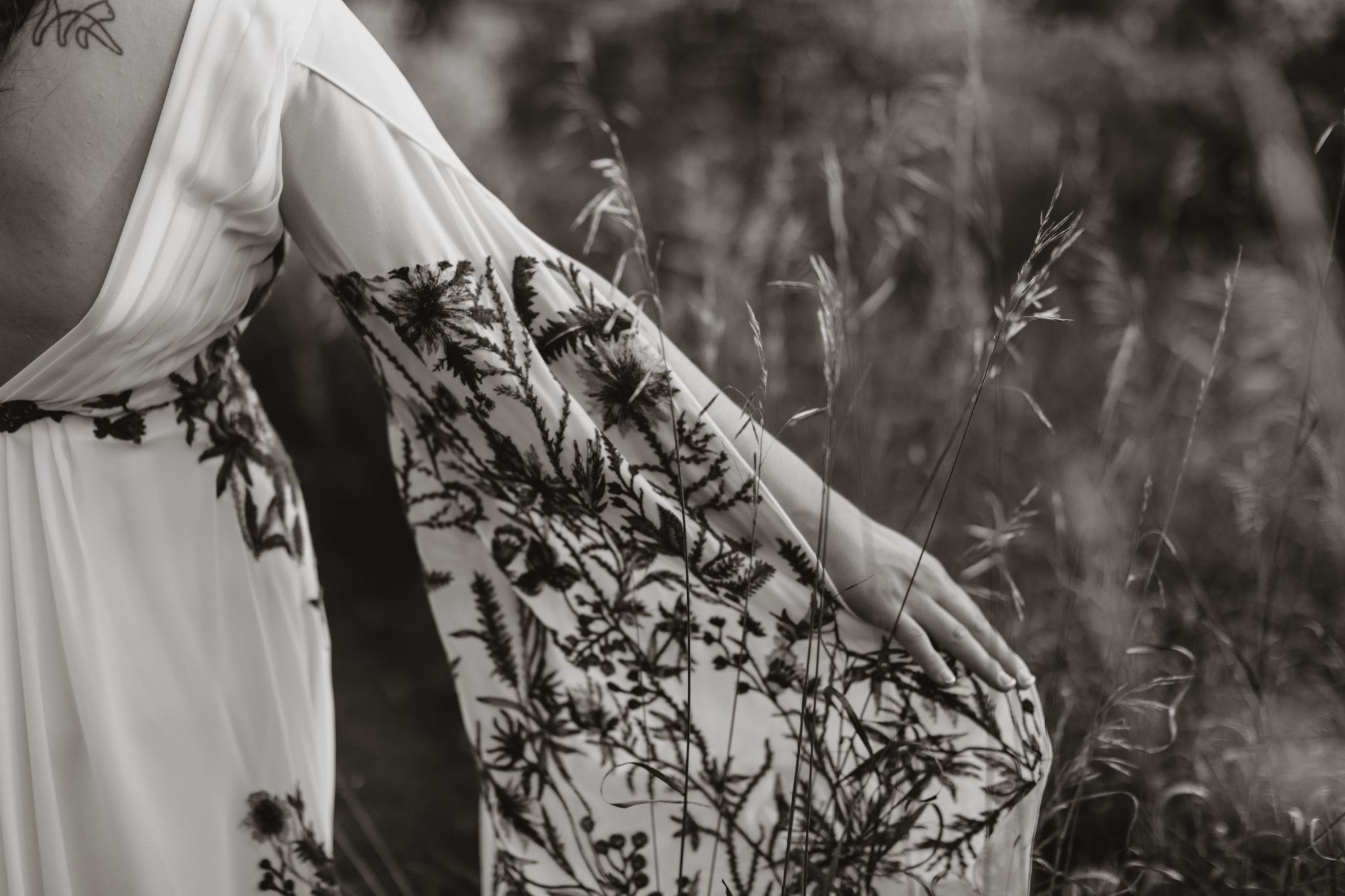 close up details of the embroidery on sleeves of brides wedding dress round top new york.