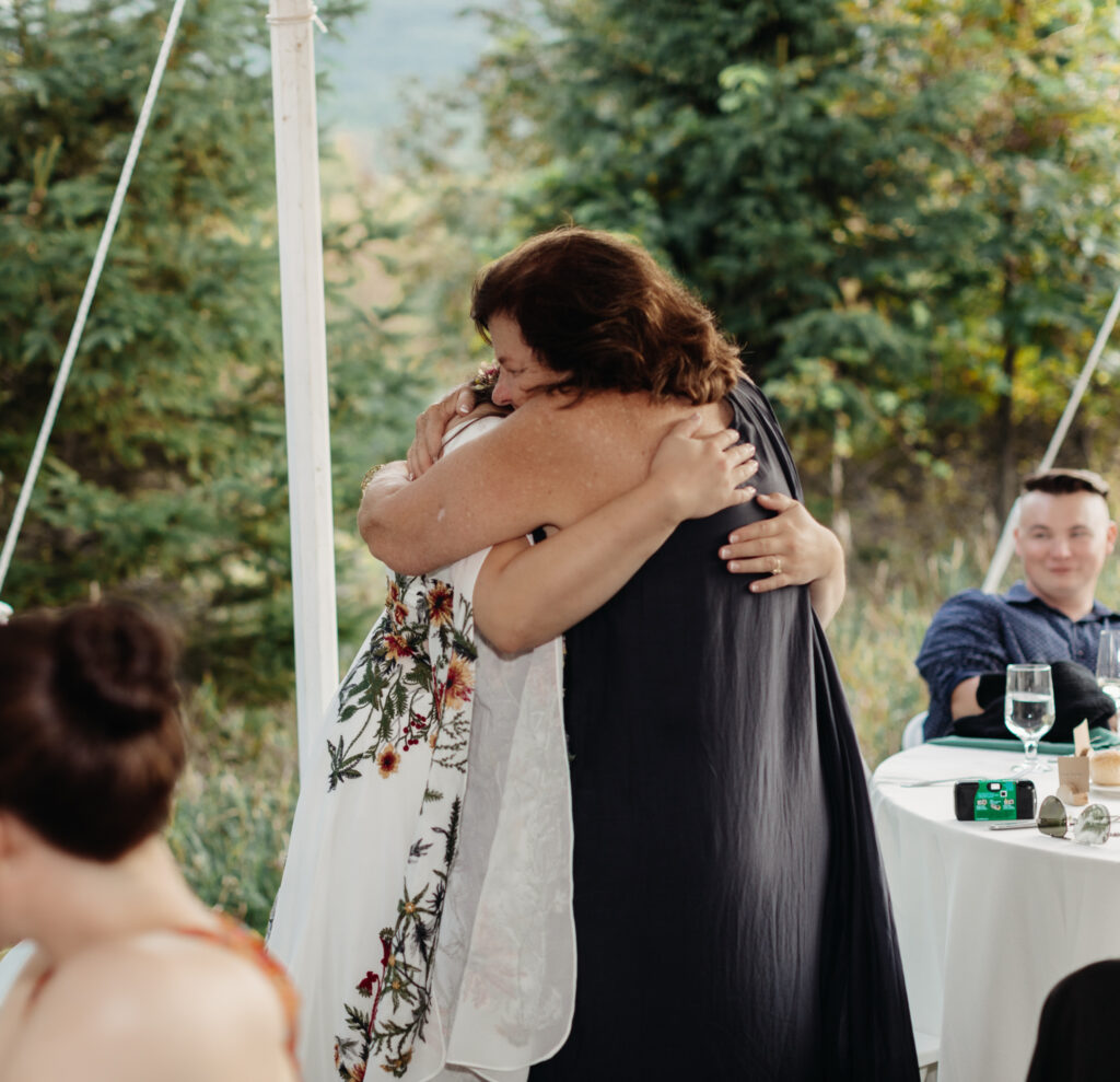 bride and mother share a hug